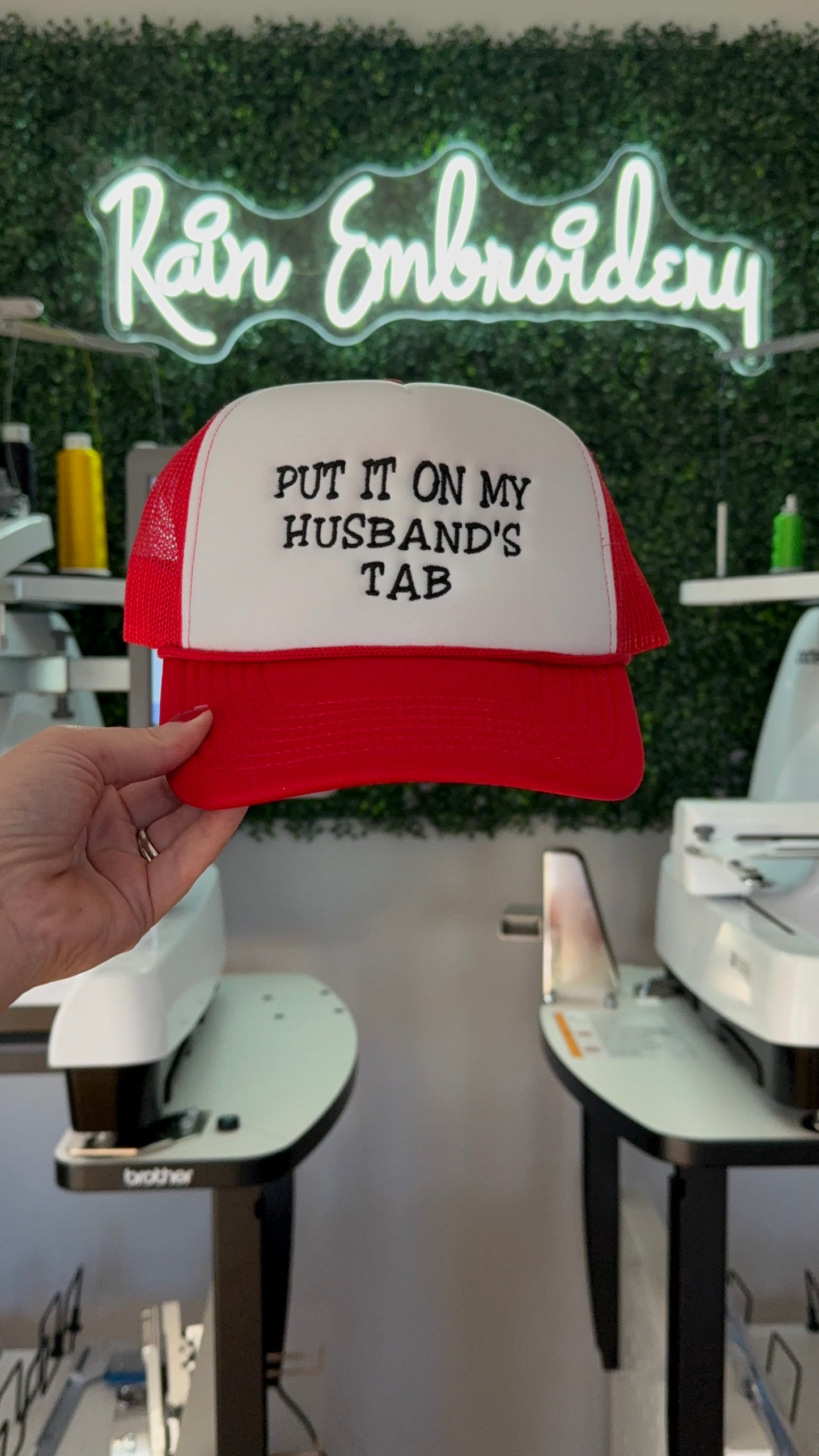 Put It On My Husband’s Tab Embroidered Trucker Hat